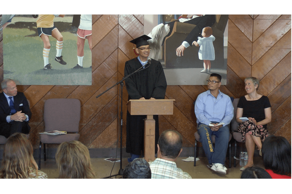 Valedictorian Angelo Falcone speaking with emcee Philip Melendez and PUP Executive Director Jody Lewen