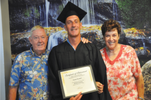 Father Kelly with graduate Danny Plunkett and mother Judy