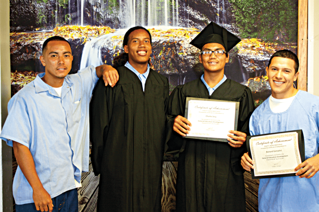 Vocational graduates Chris Nguyen, Rayven Jenkins with GED graduates Charlie Srey and Richard Gonzalez