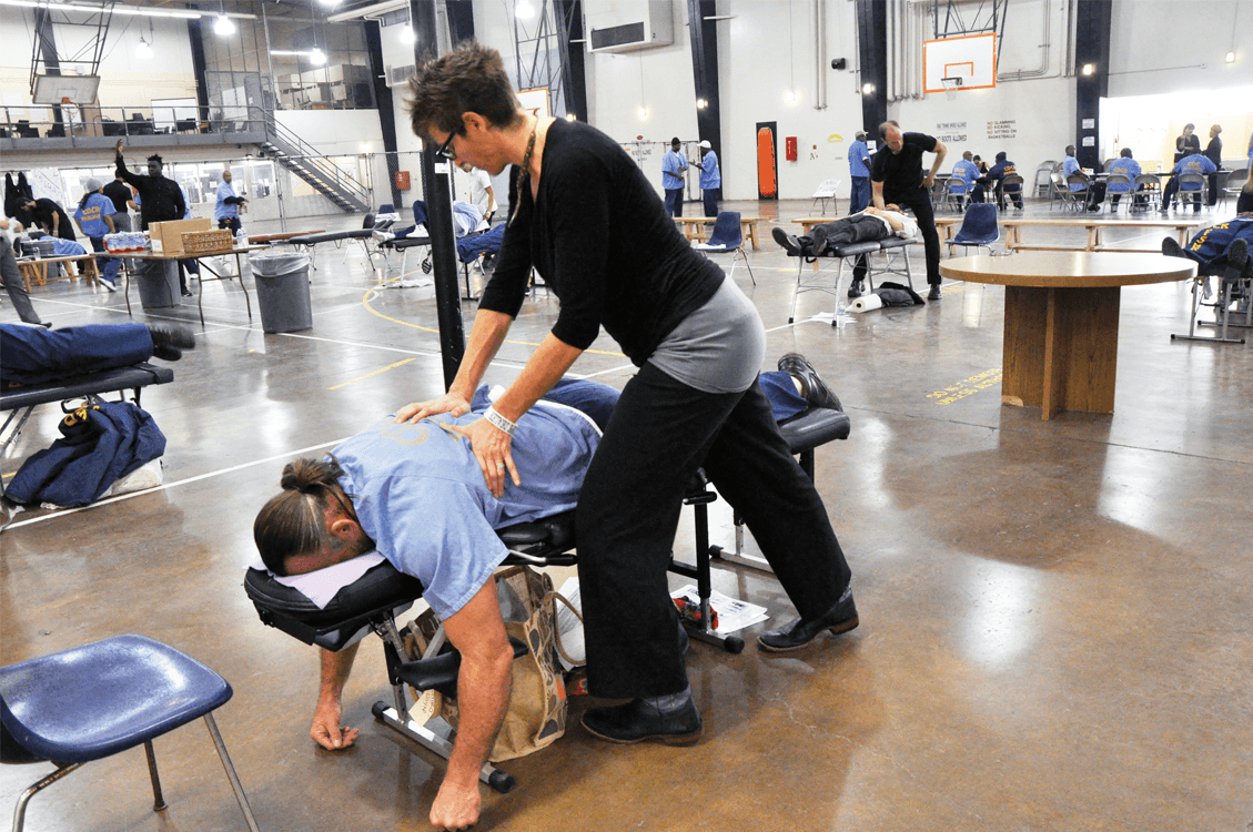 Chiropractor adjusting the back of a participant