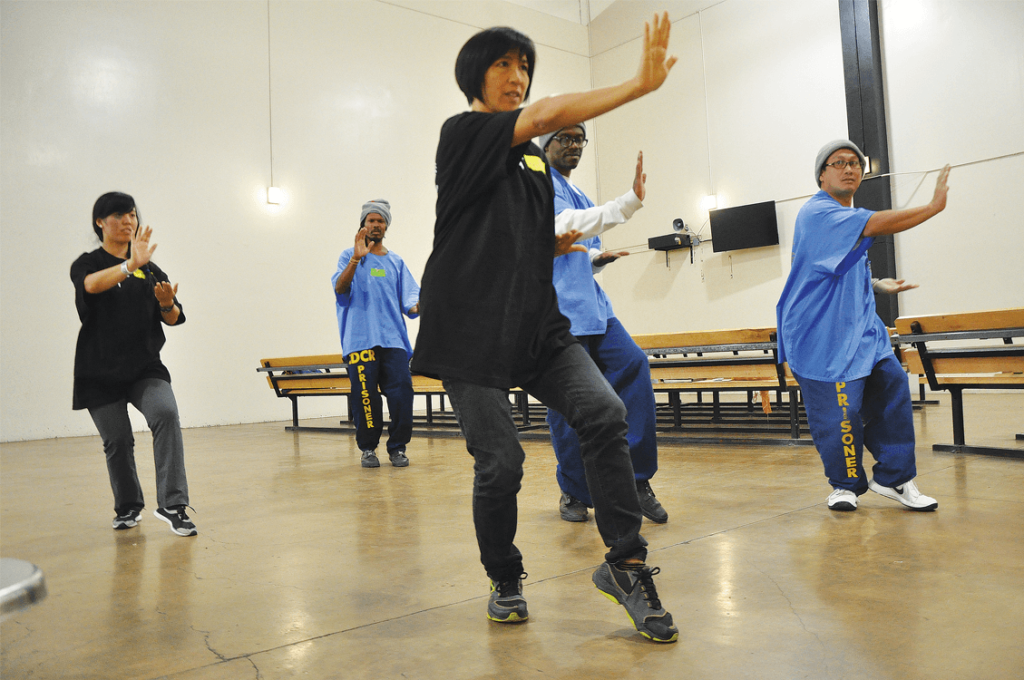 Participants learn to practice Tai Chi in the Lower Yard Gym