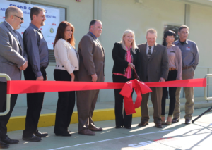 Kathleen Allison, director of the Division of Adult Institutions, cuts the ribbon at one of the facilities