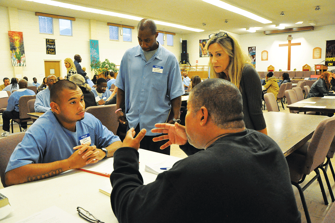 Jesse Gomez speaks with potential employers as Dianna Williams and Dwight Kennedy watch