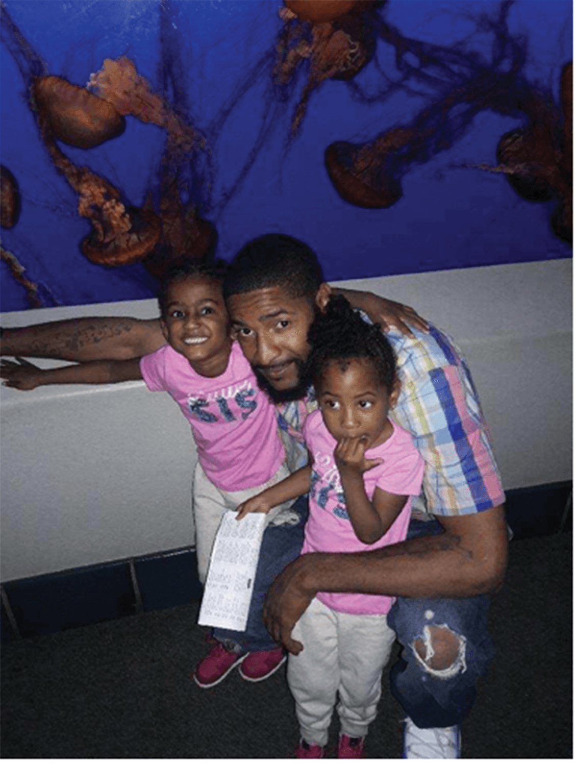 Johnson and his daughters, Naomi and Sheyane, at the Monterey aquarium