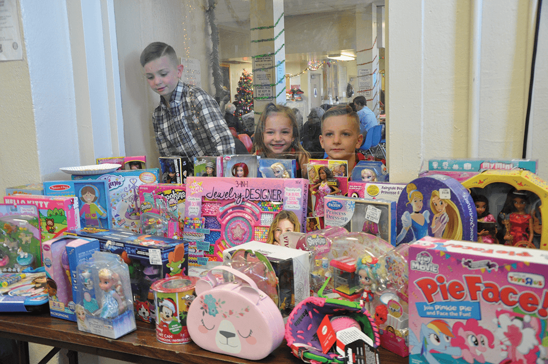 Children enjoying a day in the San Quentin visiting room with their parents and toys