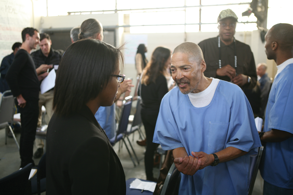 Volunteers and inmates exchanging ideas
