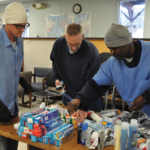 Cody Brown, Mark Hensley and Joe Hancok organizing hygiene products