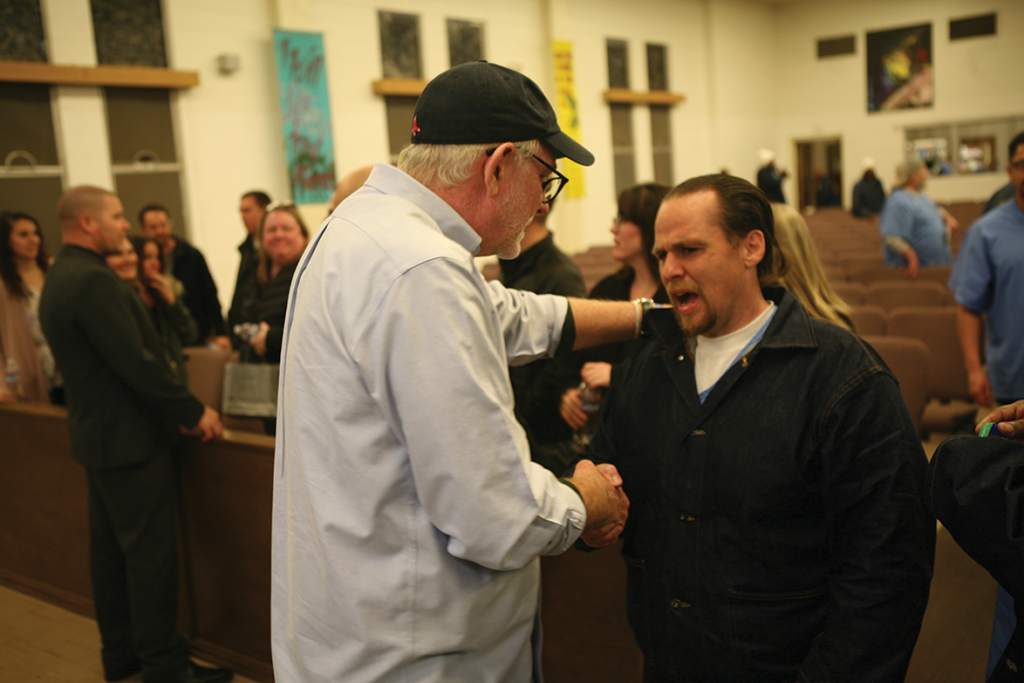 Goff speaking with a participant after the event