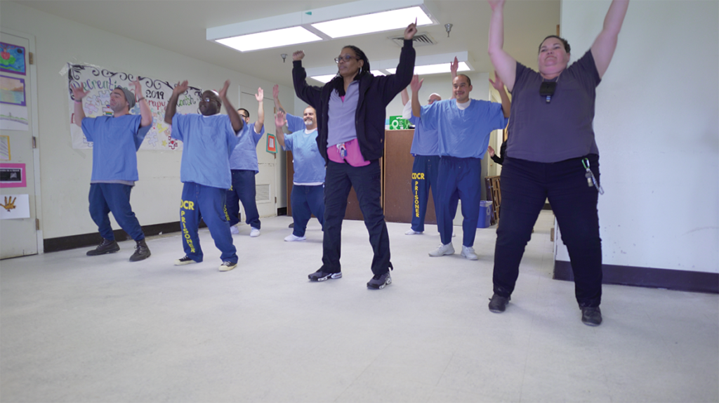 The No Limits Dance Crew with San Quentin staff performing a dance in front of an audience