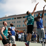 Golden State Warriors Assistant GM Kirk Lacob (green jersey) guarding Jamal Harrison (Warriors #3) on the San Quentin lower yard as Patrick Lacey challenges Delvon Adams