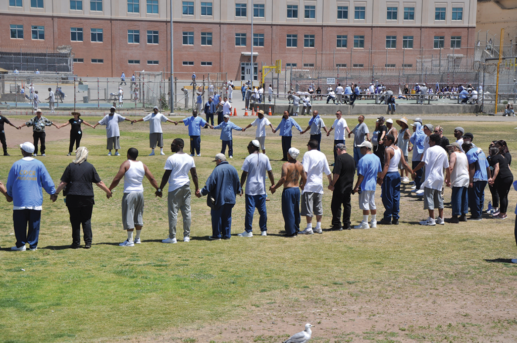 Visitors and inmates making the circle of peace at the Lower Yard