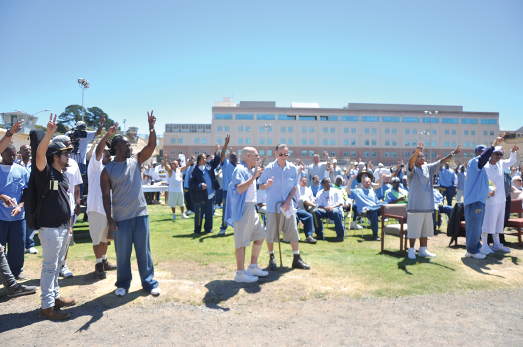 Participants raising the peace sign at high noon for the moment of silence