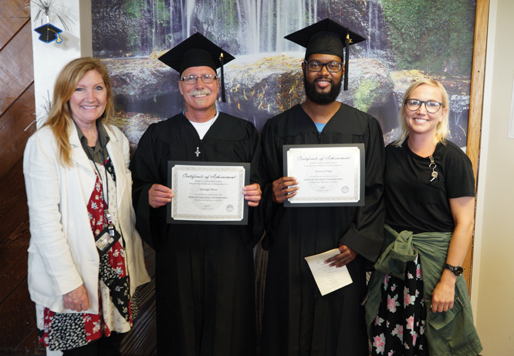 Educator D. Searle and H. Lucas with Graduate George Moss and Graduate Quincy Paige