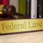 Golden sign with gavel and federal law