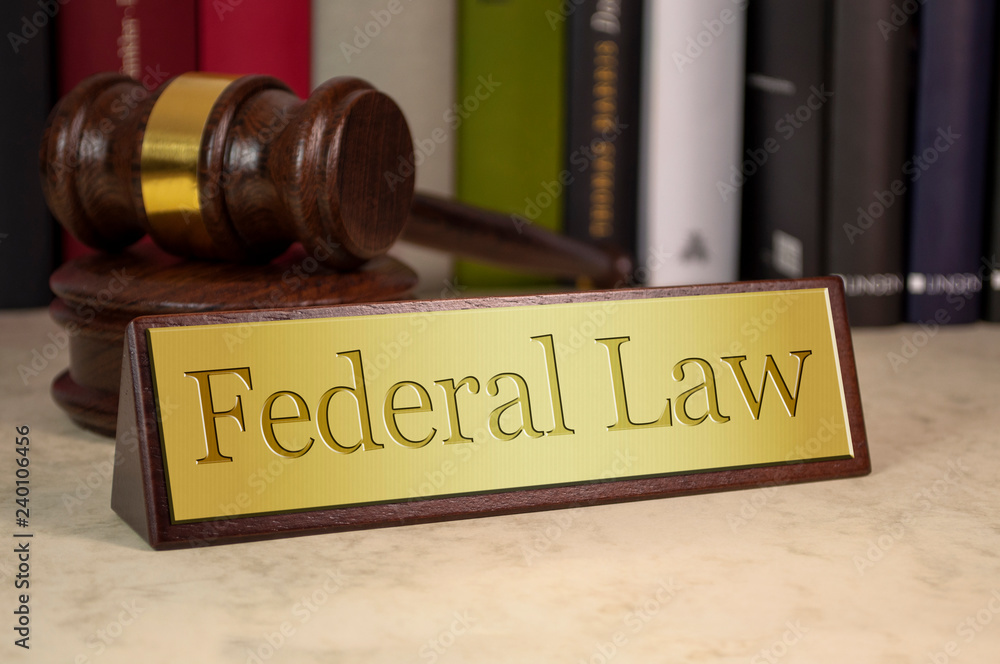 Golden sign with gavel and federal law