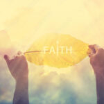 abstract, holding a yellow leaf in the clorful sky of faith, vintage tone