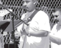 Felix Lucero playing guitar during a recent yard event