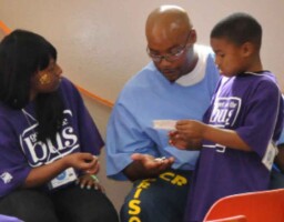 Gregory Smith Sr. visiting with his family during the ‘Get on The Bus’ event