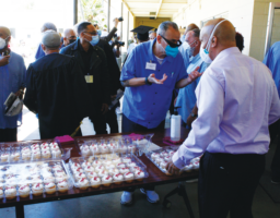Corey McNeil, former San Quentin resident, passes out sweet refreshments for the graduates and guests. Though still on parole, McNeil serves as Mt. Tamalpais College’s Alumni Affairs Associate.