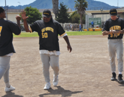 Players from seasons past share a congratulatory high-five following a Hardtimers victory over the Outsiders
