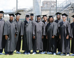 Recent incarcerated graduates of Folsom Lake College gather for a yard photo.